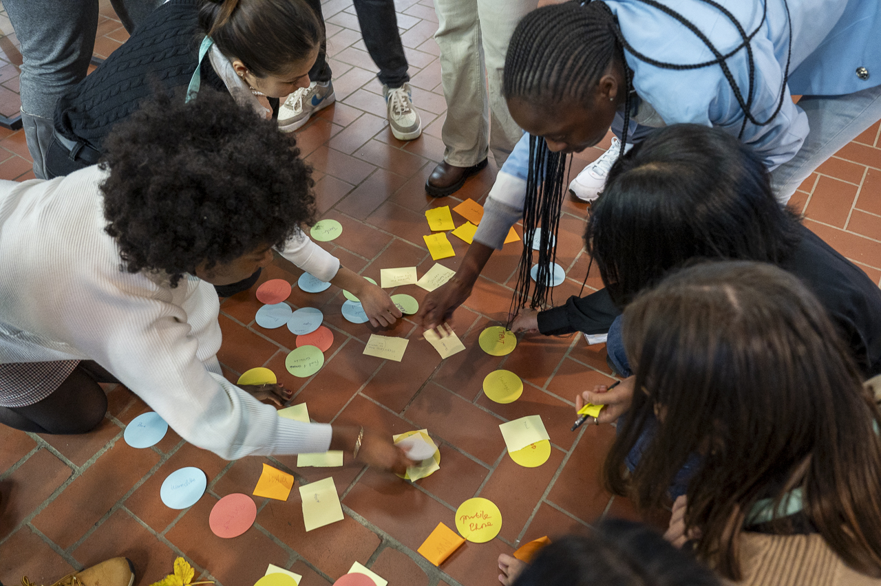 Participants of the Youth Lab play a game with colorful cards